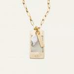 a necklace with a tag and a gold chain