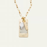 a necklace with a tag and a gold chain