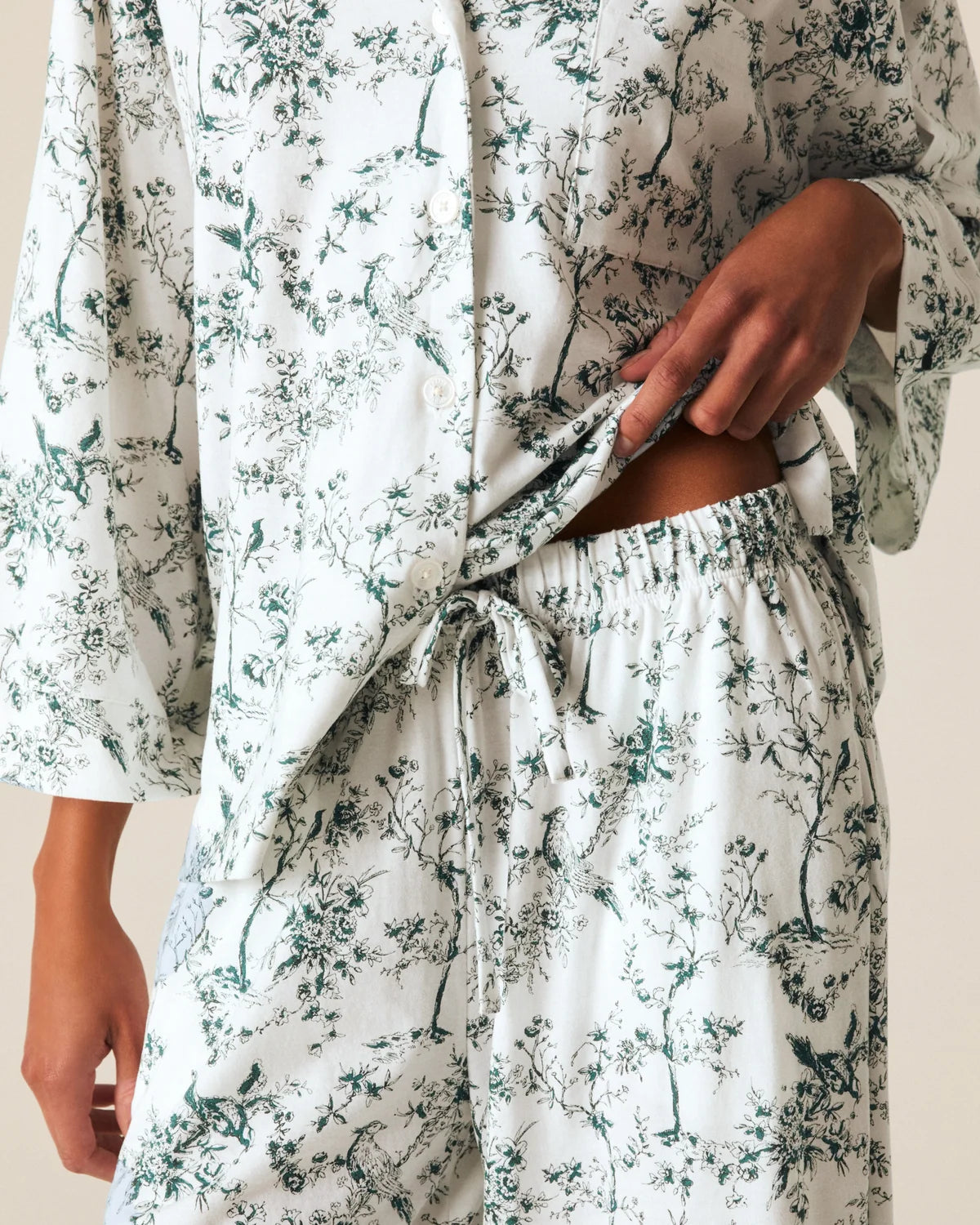 a person wearing a white and green pajamas