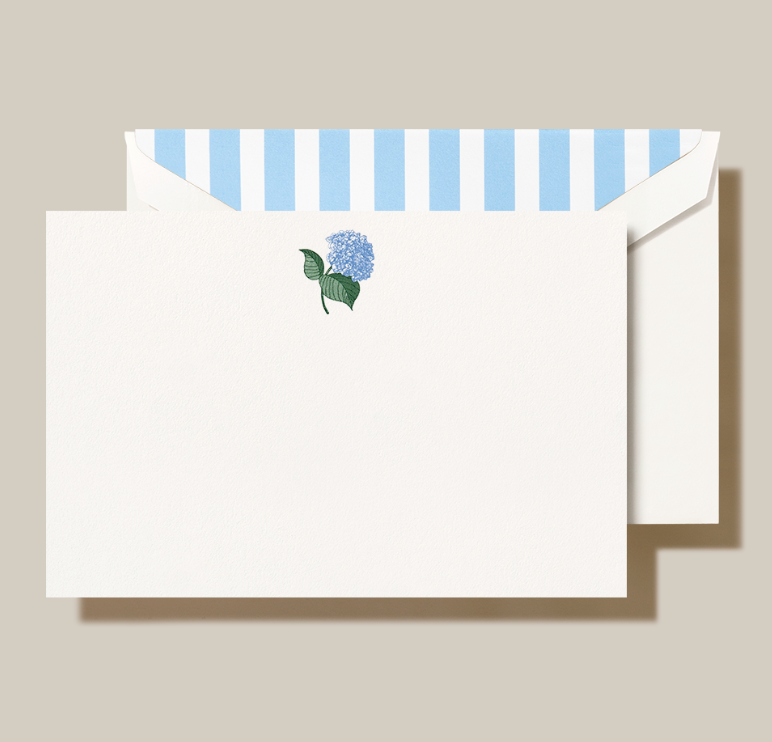 a white envelope with blue and white striped paper and a flower on it