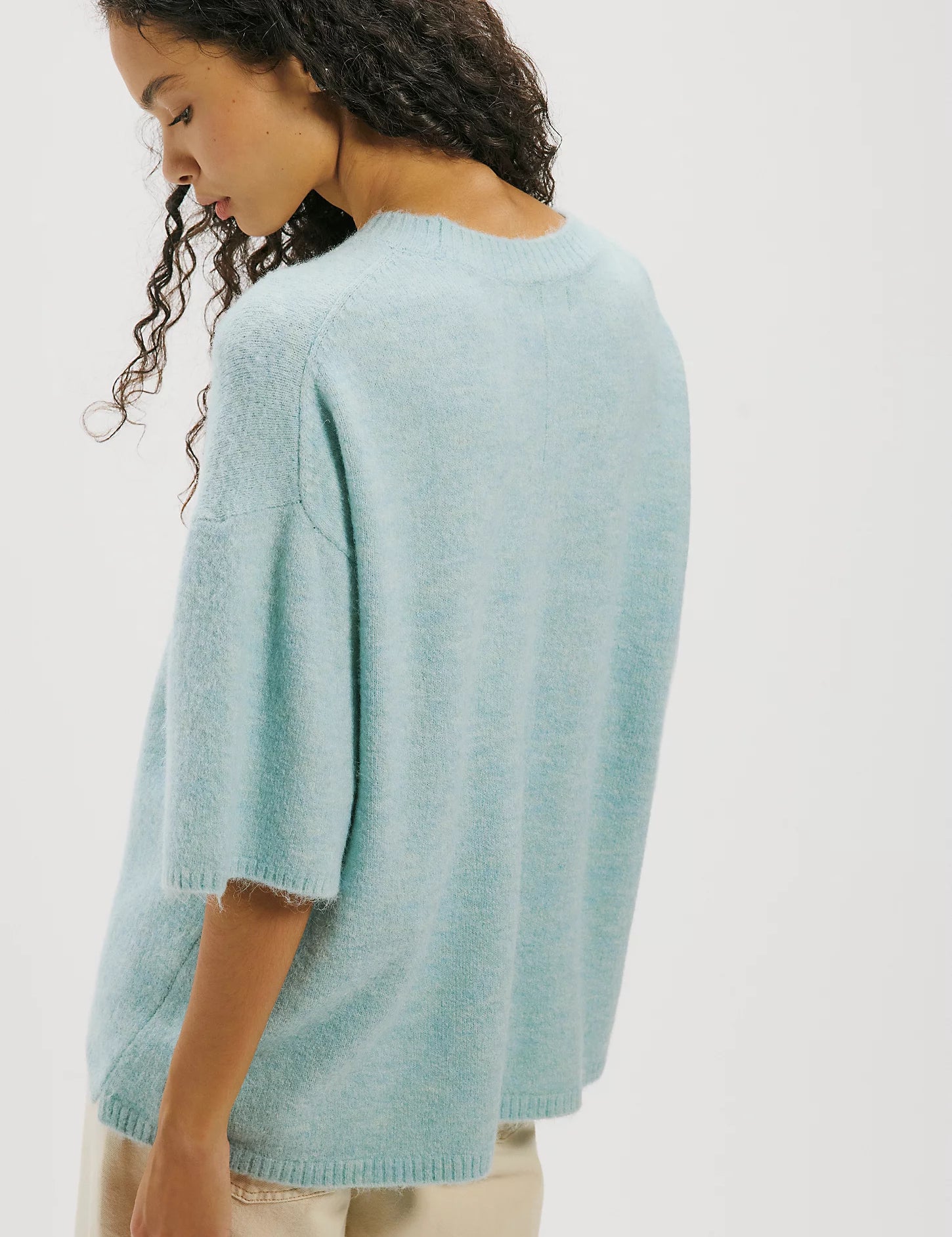 a woman in a blue sweater