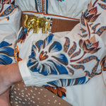 a person wearing a white shirt with blue and orange designs