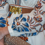 a person wearing a white shirt with blue and orange designs
