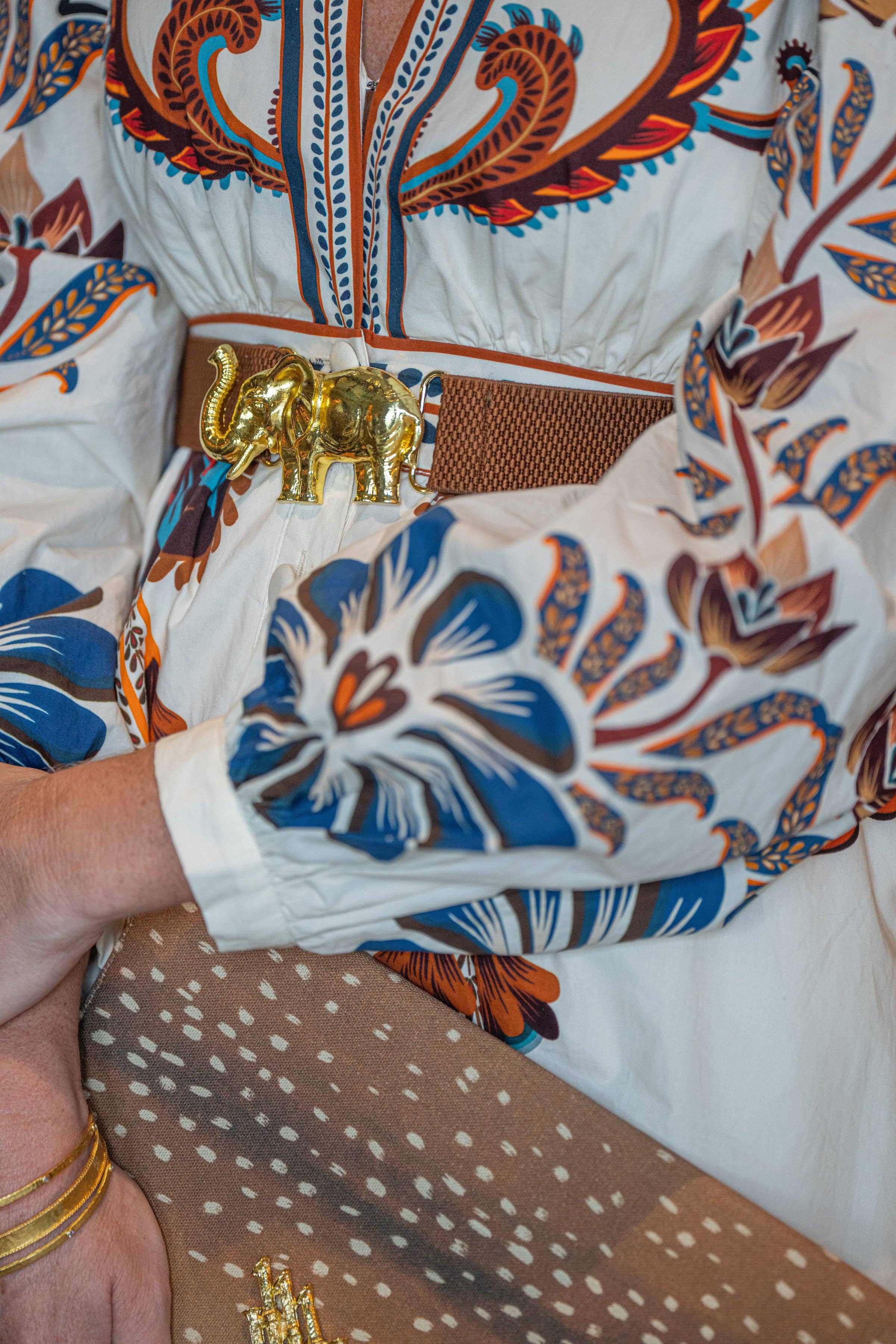a person wearing a white shirt with blue and orange designs