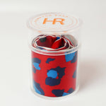 a red and blue tie in a plastic container