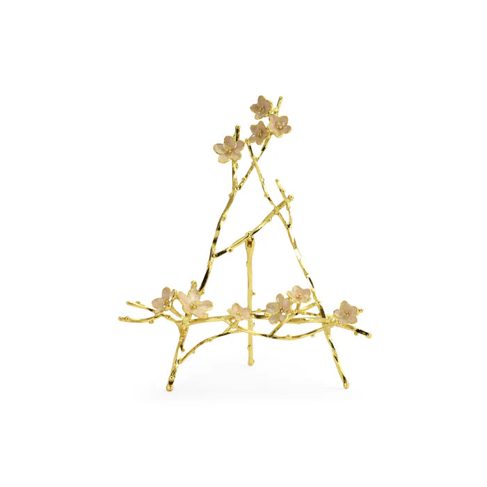 a gold object with flowers on it