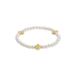 a pearl bracelet with cross on it
