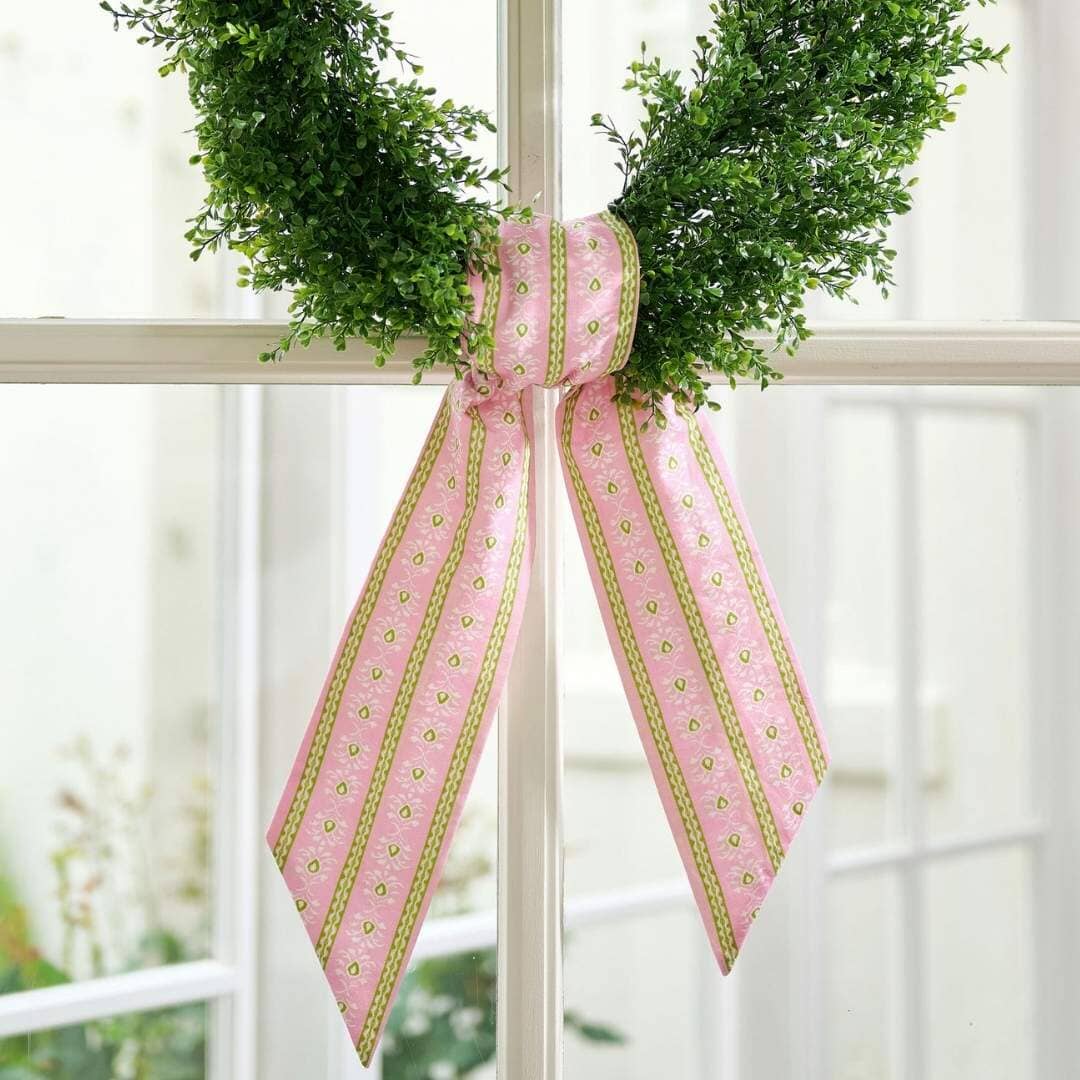 a wreath with a pink bow