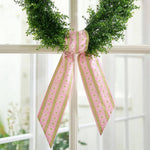 a wreath with a pink bow