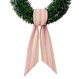 a green wreath with a pink ribbon
