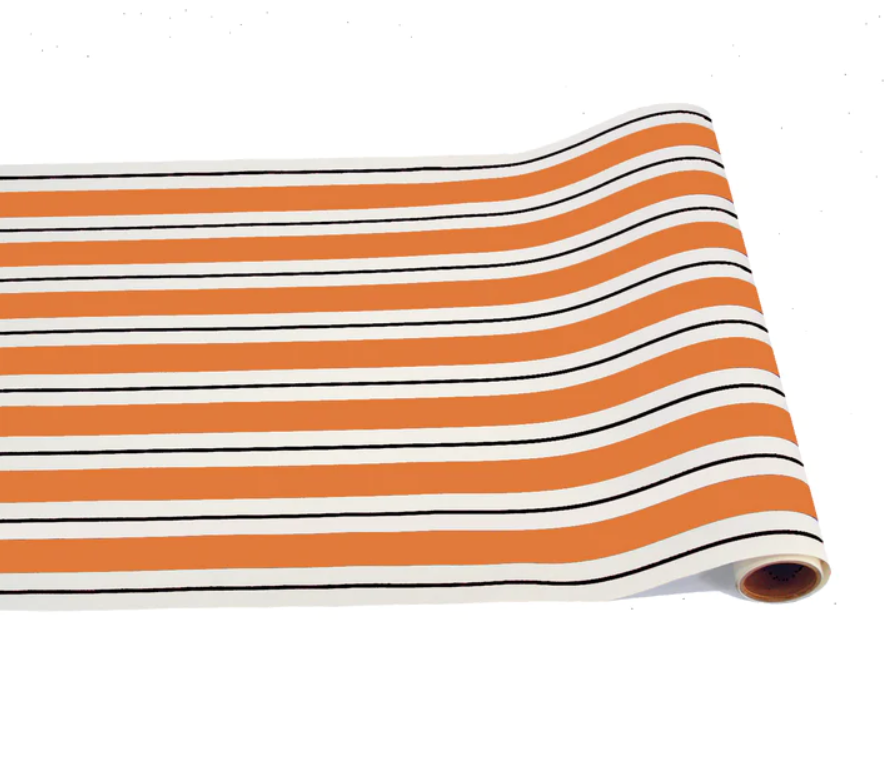 a roll of orange and white striped wrapping paper